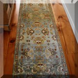 D08. Blue bordered runner rug. Measures approx 2'6” x 10' 